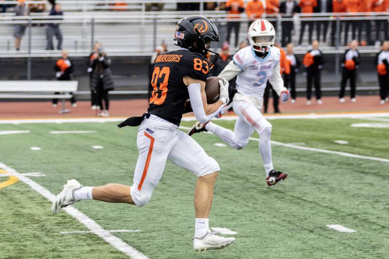 Lincoln-Way West's Braydon McNulty picks-up yardage during a 7A varsity football playoff game against Kenwood at Lincoln-Way West on Nov. 8, 2025.