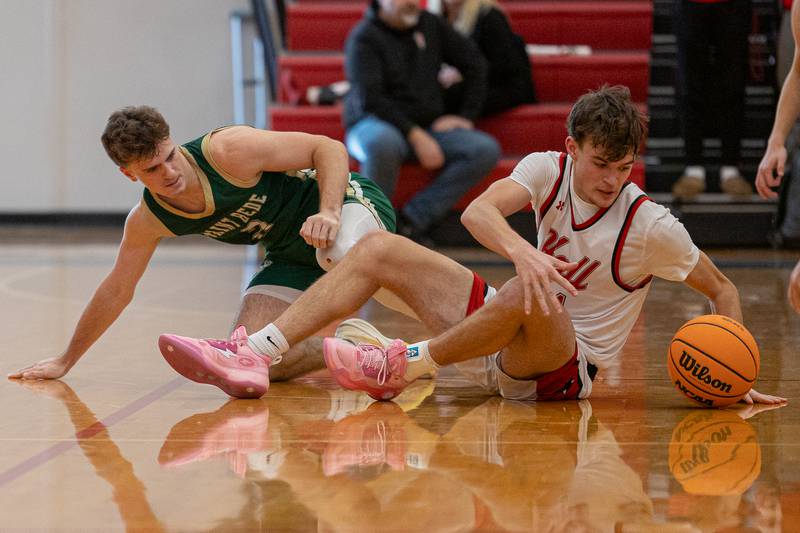 Clayton Fusinetti (21) of Hall reaches for loose ball as St. Bede's Gus Burr (2) stands back up after entanglement on Saturday, January 31, 2026 at Hall High School in Spring Valley.