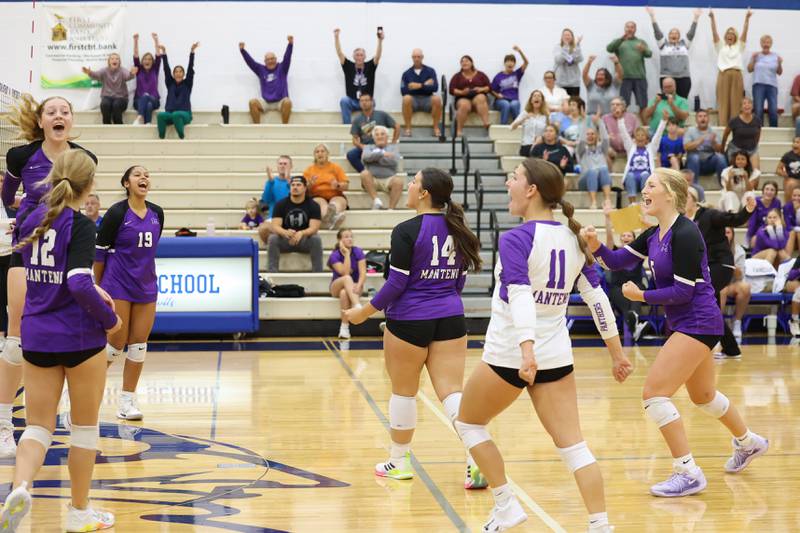 Manteno players celebrate as they secured the match point of the third set to claim victory in three sets, 19-25, 25-19, 25-21, over Peotone on Tuesday, Sept. 23, 2025.