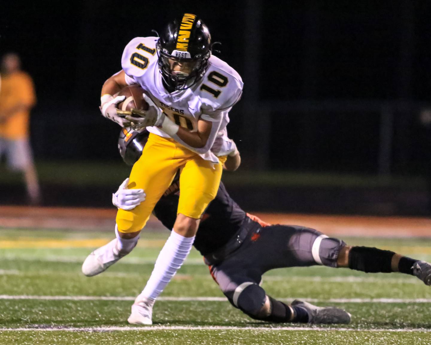 Joliet West's Parker Schwarting (10) runs after a short reception during varsity football game between Joliet West at Minooka.  Sept 2, 2022