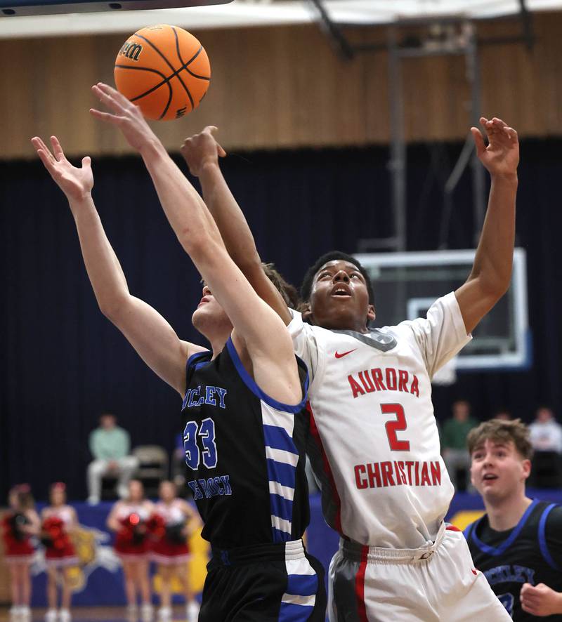Hinckley-Big Rock’s Marshall Ledbetter (left) and Aurora Christian's James Baker go after a rebound during their sectional final game Friday, March 7, 2025, at Somonauk High School.