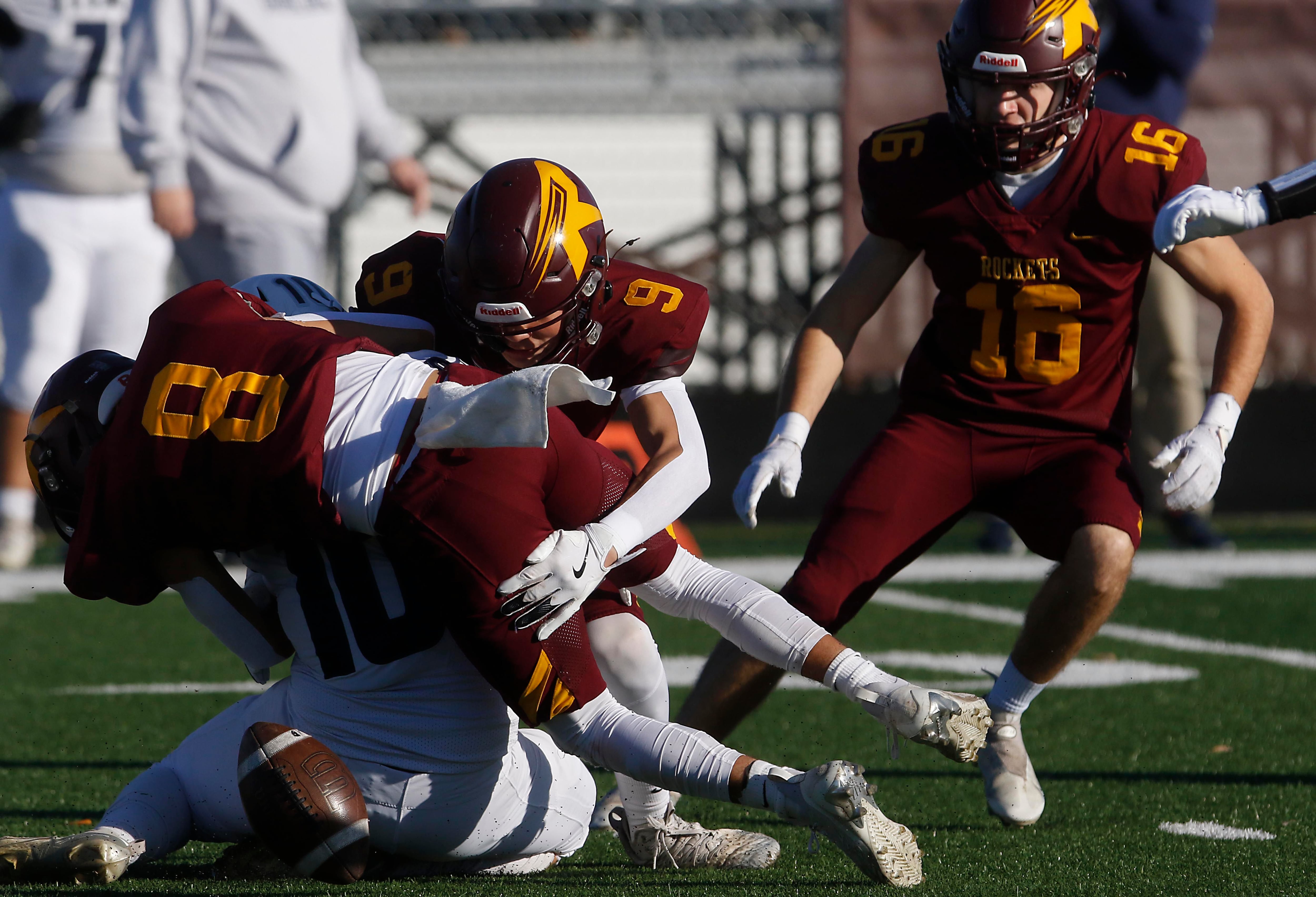 Richmond-Burton's Joseph Larsen and Cooper Nagel hit’s Monmouth-Roseville's Andrew Snyder as he tries to field the opening kick off causing him to lose the football Monmouth-Roseville was able to recover the ball during an IHSA Class 3A quarterfinal playoff football game on Saturday, November 15, 2025, at Richmond-Burton High School, in Richmond.