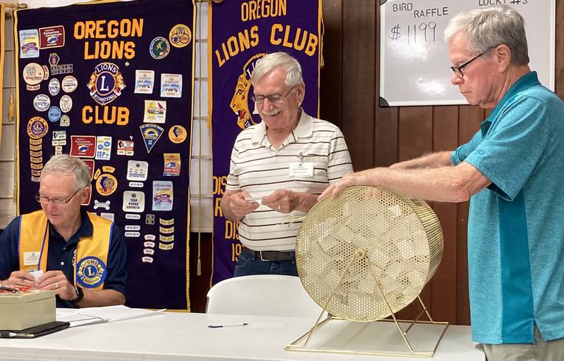 (Left to right): Oregon Lions Club members Dr. Tom Champley, Dave Stenger and Jim Hoff working at the Lions Club annual Meat Raffle