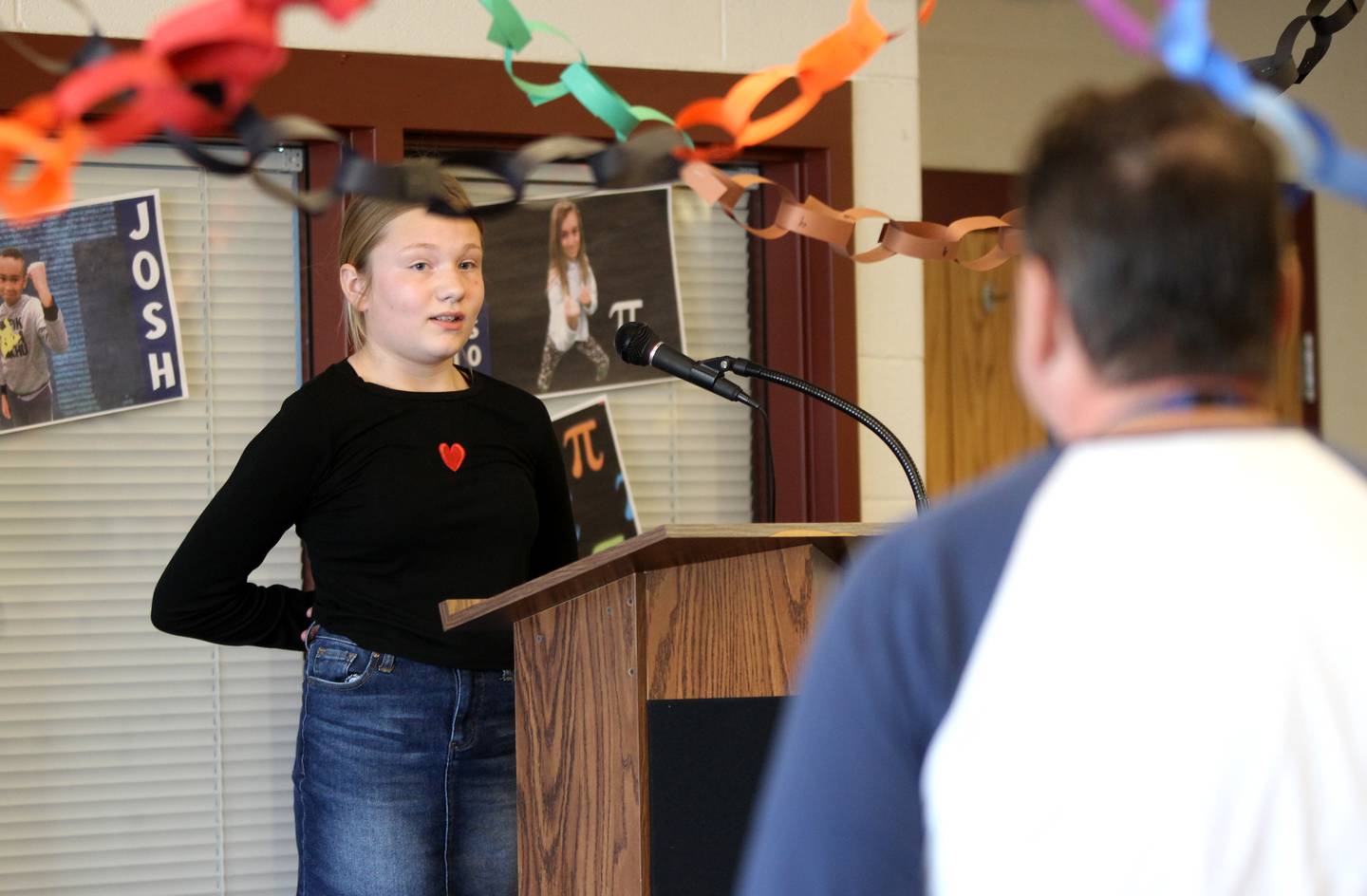 Mill Creek fifth-grader Ann Barr looks to teacher Dan Medernack as she recites as many digits of pi as she can during the Geneva school’s annual Pi Day event on Monday, March 14, 2022. Barr won the competition over her peers with over 300 digits memorized.