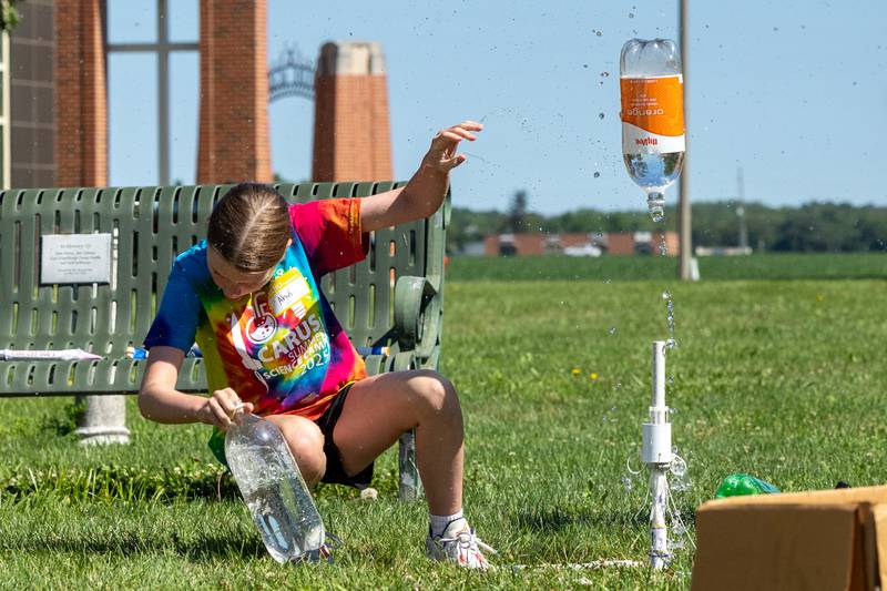 Ahvi jumps back as two liter water rocket launches during the 23rd annual Carus Summer Science Camp on Friday, July 18, 2025 at St. Bede High School in Peru.
