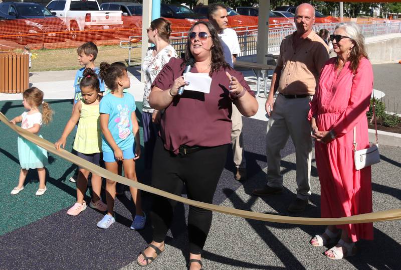 Chrissy Tluczek, superintendent of recreation with the DeKalb Park District, makes some remarks before the ribbon cutting Friday, June 14, 2024, at the new playground at Hopkins Park. The park district was hosting a Dedication Celebration event at the park for the grand opening of the new playground and racquet courts.