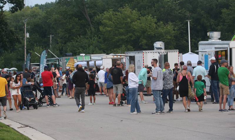 A long line of people wait their turn for food during the The Taste of the Illinois Valley on Friday, Aug. 1, 2025 at Centennial Park in Peru. The event featured food vendors, live music, a beer tent and a kids zone, Dreamwave wrestling and Pandora's Box, a Aerosmith tribute band.