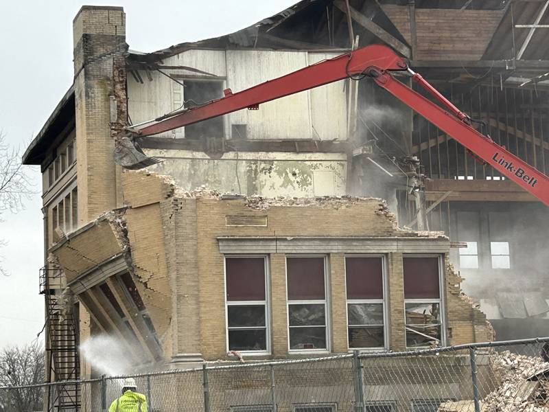 Workers from Fischer Excavating of Freeport demolish a portion of the east wall of the Congress School, 208 N. Congress Ave., on Tuesday, April 1, 2025 in Polo. Demolition of the 41,000 square foot school built in 1899 is expected to continue this week.