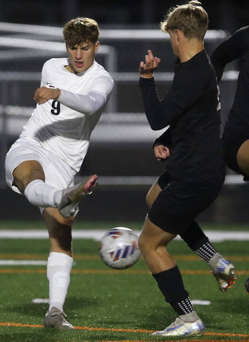 Prairie Ridge's Henry Knoll tries to take a shot at goal through the defense of McHenry's Braeden Juergensen during a Fox Valley Conference soccer match on Tuesday, Oct. 15, 2024, at McCraken Field in McHenry.