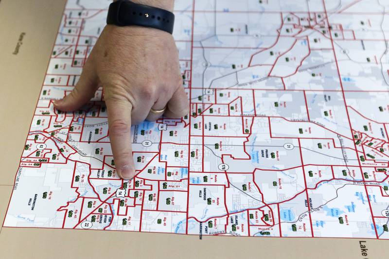 McHenry County board member Joe Gottemoller shows a current map of McHenry County voter districts and precincts on Friday, April 30, 2021 in Crystal Lake. The county is considering redistricting and is awaiting updated census information.