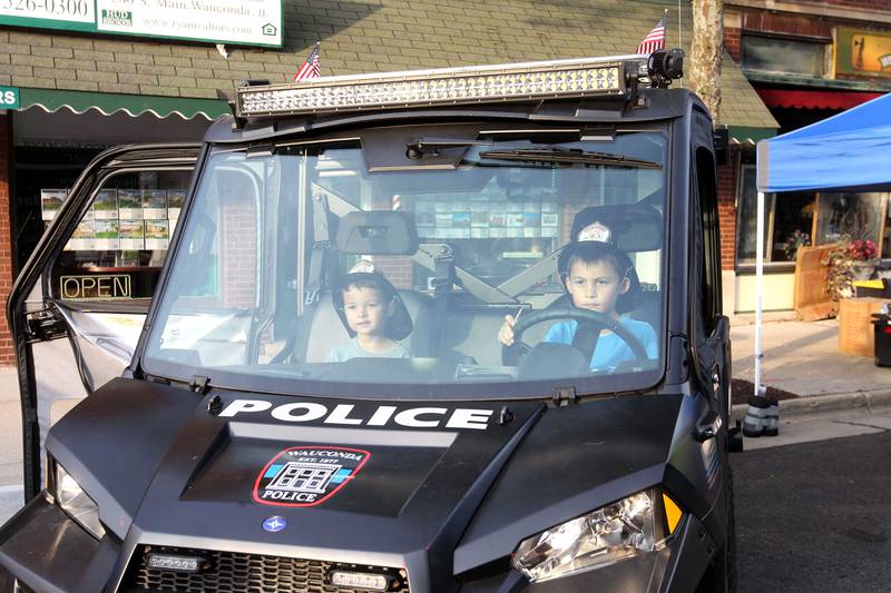 Casper Nono, 5, of Huntley and his brother, Phillip, 8, check out a Wauconda Police Department ATV during National Night Out on Main Street on Tuesday, August 1st in Wauconda.  
Photo by Candace H. Johnson for Shaw Local News Network.
