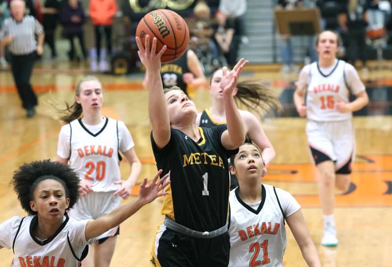 Metea Valley's Reese Valha scores between DeKalb's Madison McNeil and Alicia Johnson during their game Thursday, Jan. 19, 2023, at DeKalb High School.