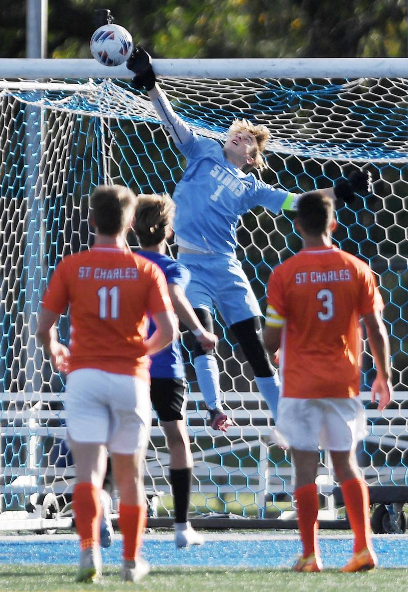 John Starks/jstarks@dailyherald.com
St. Charles North goalkeeper Alex Curtis stops a St. Charles East shot in the TriCities boys soccer night game in Geneva on Tuesday, September 27, 2022.