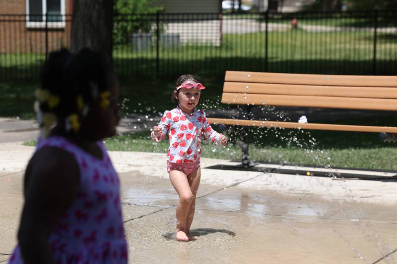 Lillian Welch, 4, from Davis Junction, runs through the water Tuesday, June 24, 2025, on the splash pad at Welsh Park in DeKalb.
