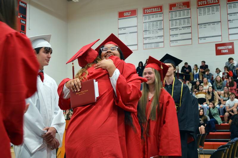 Carli Hollis, right, and Sydney Greenfield hug as the Forreston High School Class of 2023's commencement nears its end on May 14, 2023. Hollis and Greenfield both plan to study nursing at Highland Community College.