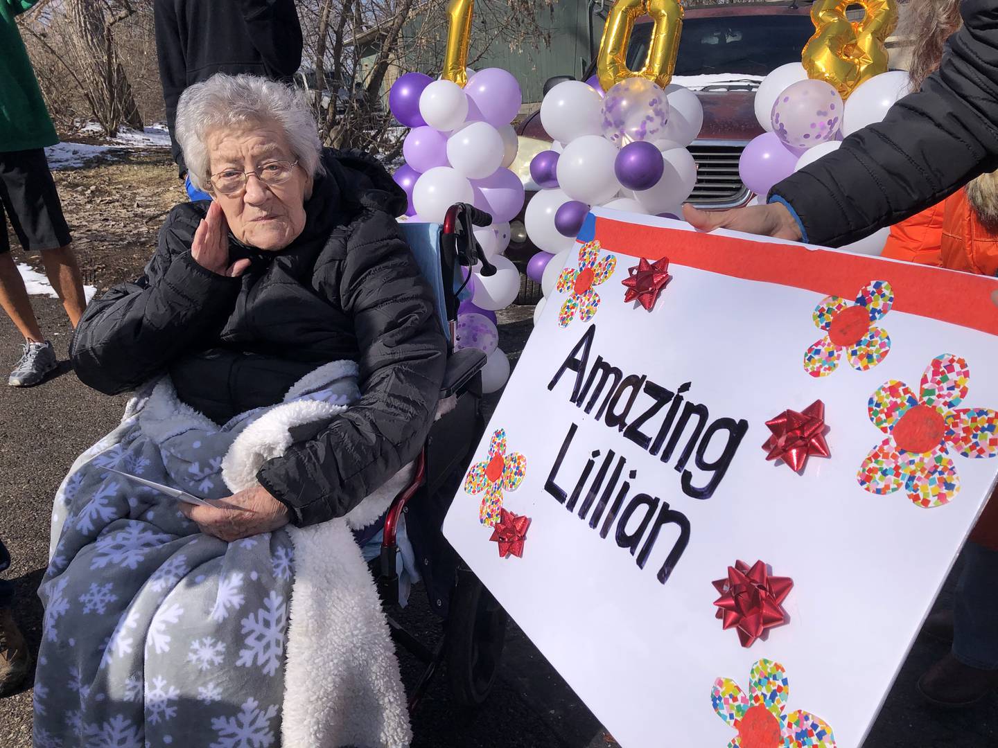 Spring Grove resident Lillian Bennett looks at a birthday card following her 108th birthday party parade Feb. 24, 2024.