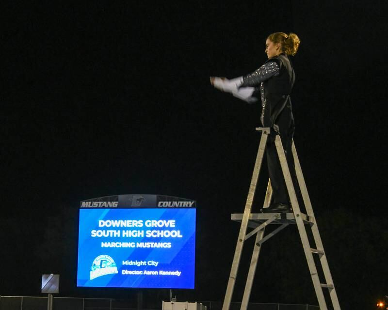Downers Grove South drum major Rebecca Snouffer conducts the Downers Grove South Marching Music mustang on 5. 2024.