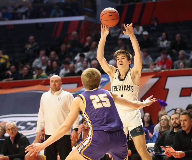 New Trier's Quinn Finerty passes the ball over the head of Downers Grove North's Alex Miller in the Class 4A state third place game on Friday, March 10, 2023 at the State Farm Center in Champaign.