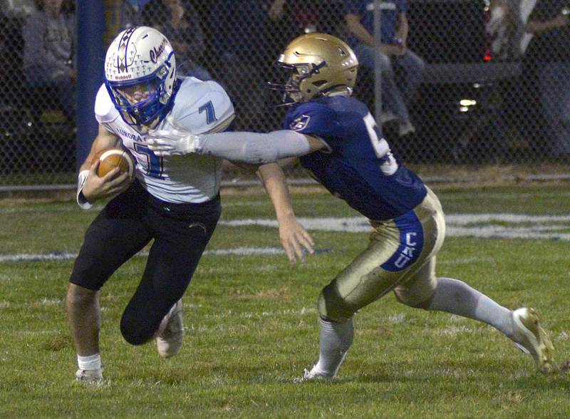 Marquette’s Austin Ferracutti brings down Aurora Central Christian’s Grant Bohr on a run in the 1st quarter Friday at Marquette.