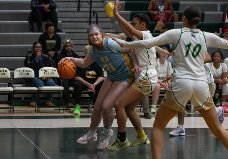 Joliet Catholic's Emma Birsa drives to the lane under pressure during their game against Bishop McNamara on Wednesday, Feb. 11, 2026.