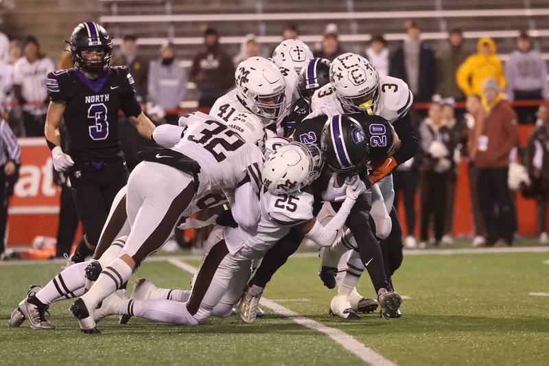 Mt. Carmel’s special teams wraps up Downers Grove North’s Noah Battle in the Class 7A championship on Saturday, Nov. 25, 2023 at Hancock Stadium in Normal.