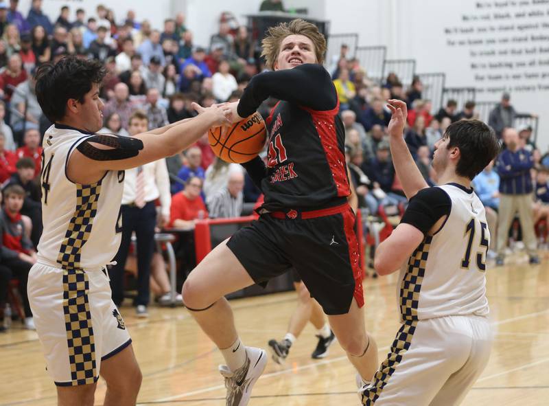 Marquette's Matthew Graham knocks the ball free from Indian Creek's Parker Murry during the Class 1A Sectional game on Friday, March 6, 2026 at Amboy High School.