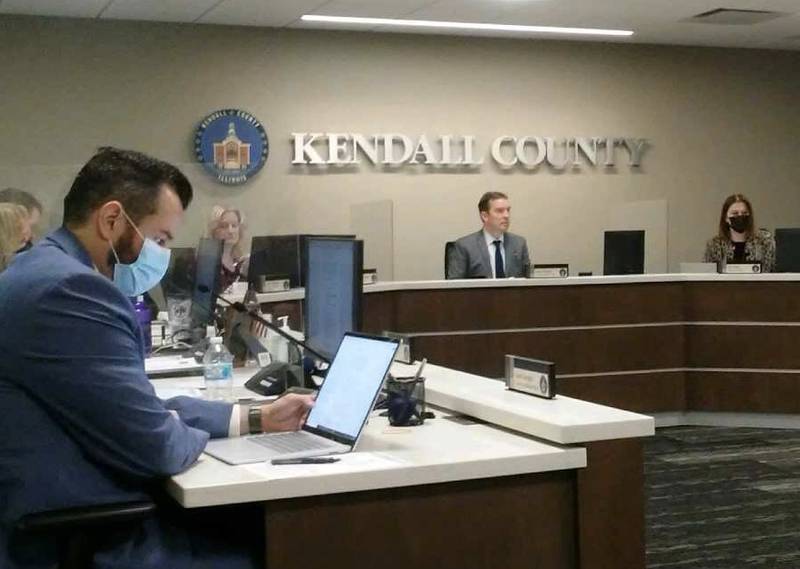 Kendall County Administrator Scott Koeppel, left, and County Board Chairman Scott Gryder, center, at the Jan. 18, 2022 county board meeting in Yorkville.