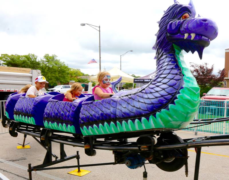 Kids ride the dragon rollercoaster at the annual Batavia Windmill City Festival on Saturday, July 12, 2025.