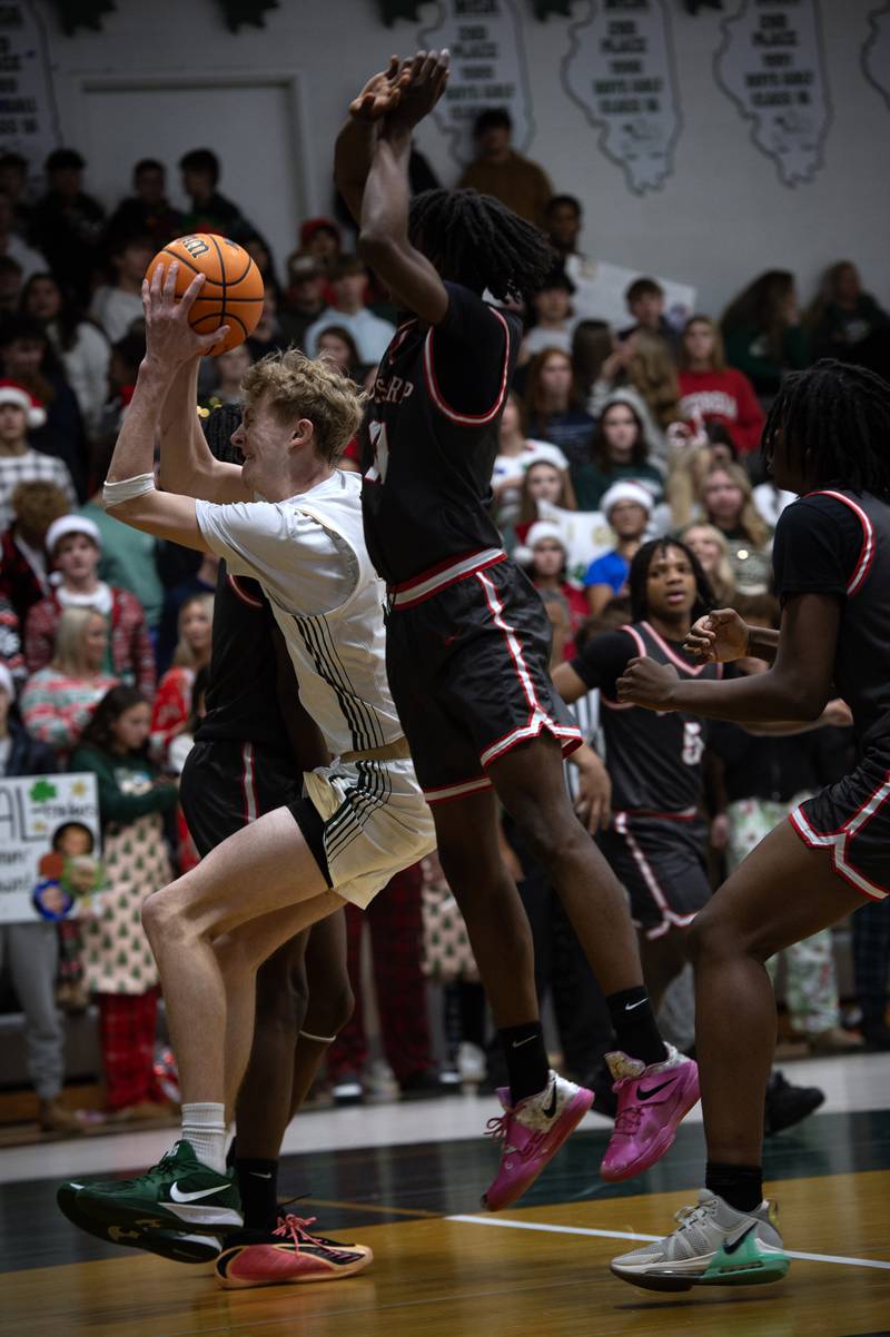 Bishop McNamara's Richie Darr, left, moves the ball as Chicago Bulls Prep's Jamir Seymore, center, guards in a game on Friday, December 19, 2025.