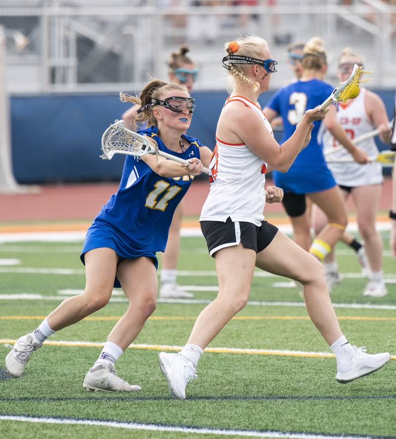 Lake Forest's Carly Kisselle defends against Crystal Lake Central Co-Op's Maddi Lieflander during the girls lacrosse supersectional match on Tuesday, May 31, 2022 at Hoffman Estates High School.