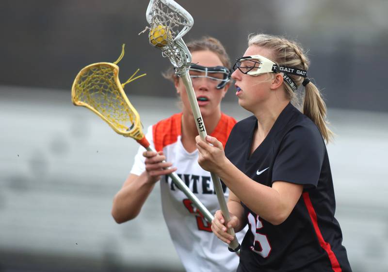 Huntley’s Katie Ferrara moves the ball in varsity girls lacrosse on Friday, April 18, 2025, at Metcalf Field on the campus of Crystal Lake Central High School in Crystal Lake.