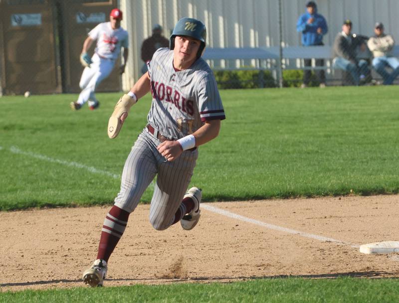 Morris's Brycen Johnston rounds third base to score a run as the ball sails into left field on Monday, April 20, 2026 at Ottawa High School.