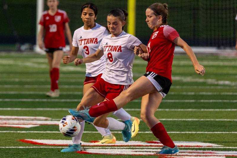Callie Sturgell (17) Of Metamora stops ball as Georgia Kirkpatrick (8) of Ottawa attempts to dribble it on Tuesday, May 21, 2025 at Malone Field in Metamora.