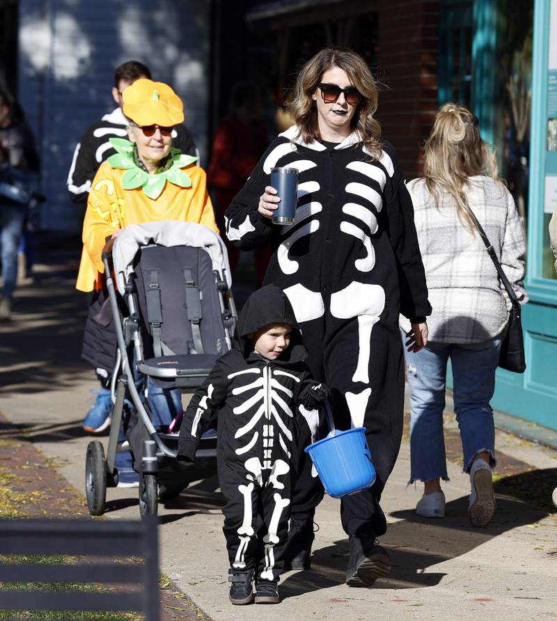 Dressed as skeletons, Krista Whitehair and her son Max Witek, both of Geneva, trick-or-treat Thursday, Oct. 30, 2025 in Geneva.