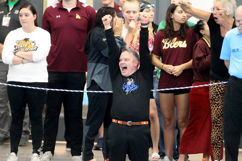 St. Charles North coach Rob Rooney celebrates swimmer Isabelle Beu in the 200-yard individual medley during the IHSA Girls State Championships preliminaries at the FMC Natatorium in Westmont on Friday, Nov. 11, 2022.