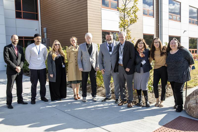 Stepping Stones staff members, supporters, and elected officials take a photo outside the organization’s new Women and Children Recovery Home on Oct. 30, 2025.