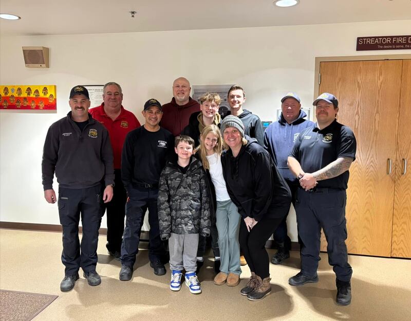 Streator Firefighters pose with the family they rescued from a house fire. The family visited the firehouse to thank the firefighters by bringing food for the crew on shift.