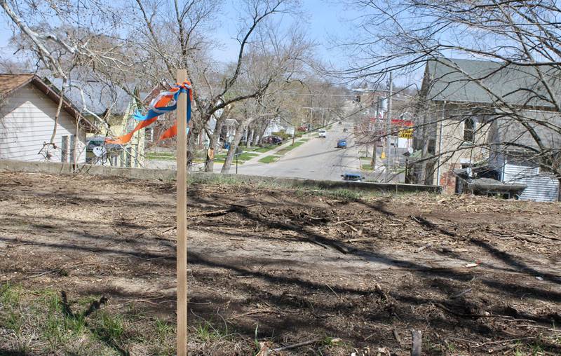 A clearing marker is seen from on top of the Illinois Central Railroad stone arch bridge looking east along West Third Street in Dixon on Tuesday, April 11, 2023. Evidence of clearing in recent weeks is visible along the path that runs north-and-south atop the Illinois Central Railroad stone arch bridges on Tuesday, April 11, 2023. Dixon was awarded a $2.25 million state grant for a bike path extension.