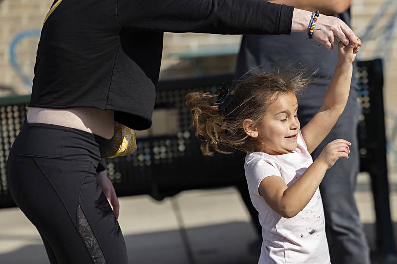 Ariana Durham, 5, dances with friend Rachel Adams in the street Saturday, Oct. 21, 2023 at Dixon’s Scarecrow Fest. Impromptu street dances and music popped up during the festival.