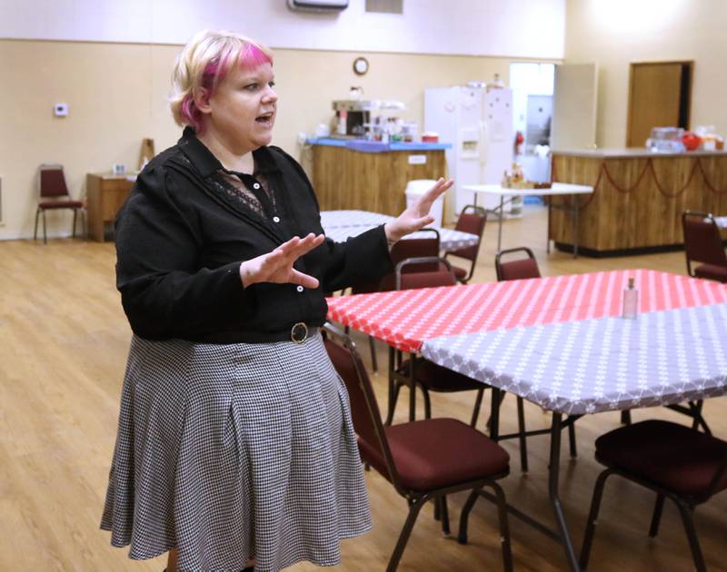 Ash Rootes, director of the overnight warming center at the Unitarian Universalist Fellowship of DeKalb, talks Thursday, Jan. 23, 2025, at the church, about the main eating and sleeping area at the facility. The warming center, which is open nightly during the winter months, offers free hot meals to all and a warm, safe place for community members.