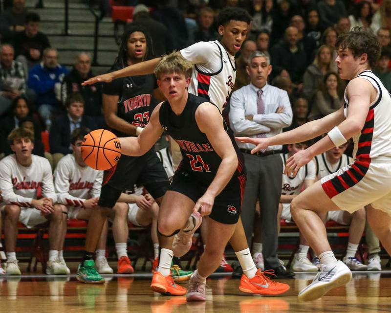 Yorkville's Frankie Pavlik (21) drives baseline during their Class 4A Bolingbrook Sectional semifinal basketball game between Yorkville at Benet, March 3, 2026 in Bolingbrook.