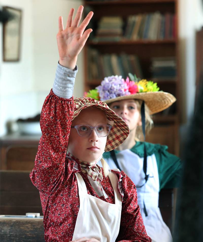Southeast Elementary School third graders Brynlee Monney raises her hand Tuesday, Nov. 4, 2025, during a field trip to North Grove School, a one-room schoolhouse from 1878 in Sycamore.