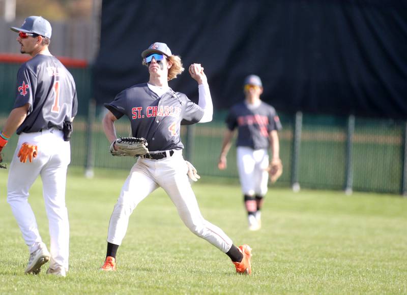 St. Charles East’s Joe Arend (center) throws the ball infield during a home game against Geneva on Friday, April 28, 2023. East won 7-6.