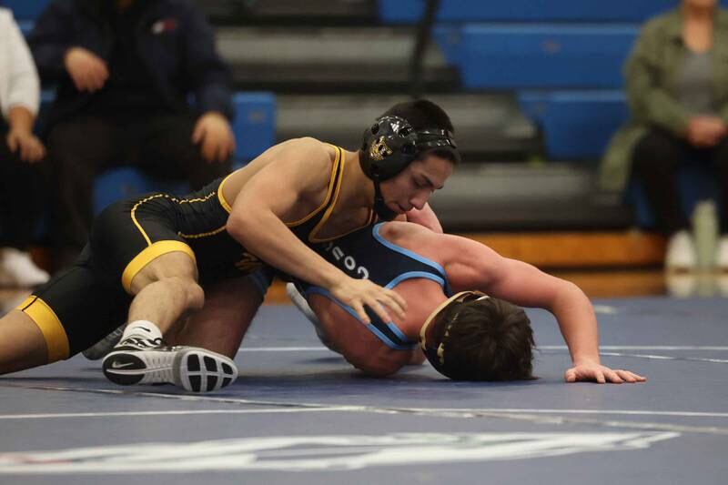 Joliet West’s Joseph Pedrosa rolls Plainfield South’s Travis Rebout in the 126-pound match on Wednesday, Dec. 11, 2024 in Plainfield.
