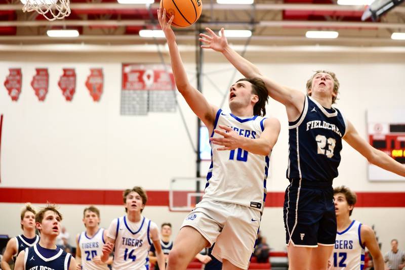 Princeton's Gavin Lanham gets past Fieldcrest's Jordan Reinhardt for a layup Tuesday night at Hall High School.