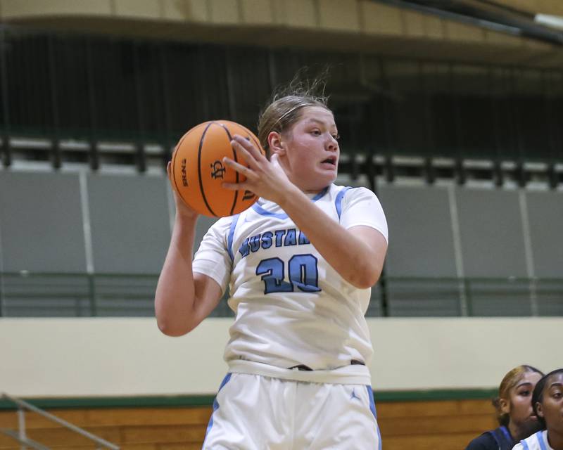 Downers Grove South's Megan Ganschow (20) comes down with a rebound during their York Thanksgiving Tournament matchup between Oswego East at Downers Grove South Friday, Nov 20, 2025 in Elmhurst.