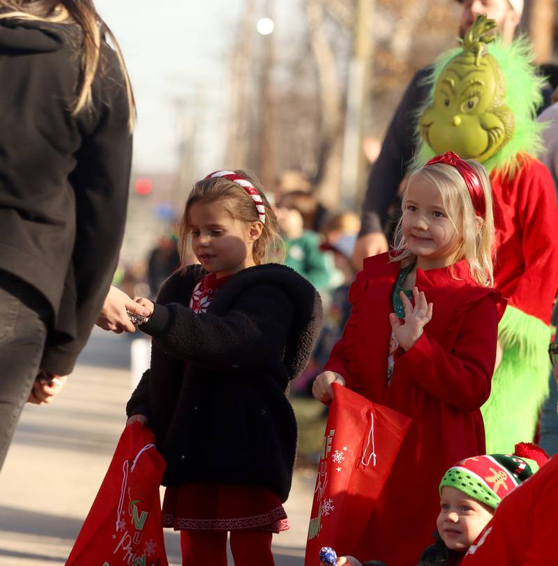 Children wait for candy during a parade along West Main Street as part of Merry Cary events Sunday, Dec. 8, 2024 in Cary.
