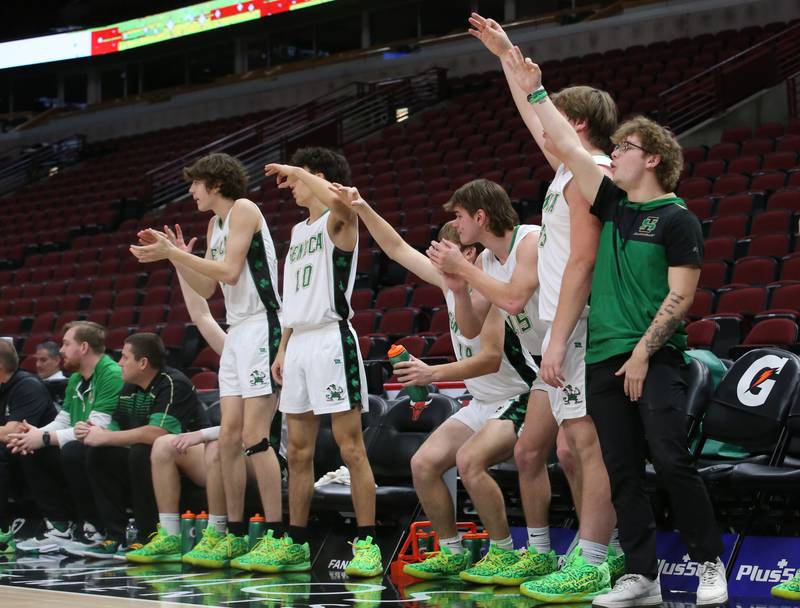 Members of the Seneca boys basketball team react after a player scores a basket during a game against Streator on Tuesday, Dec. 21, 2023 at the United Center in Chicago.
