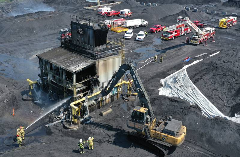 Firefighters spray water on a structure at Washington Mills on  Monday, Aug. 18, 2025 near Hennepin. A Mutual Aid Box Alarm System (MABAS) call was placed shortly after 11a.m. Fire departments from La Salle, Bureau and Putnam Counties assisted with the fire.