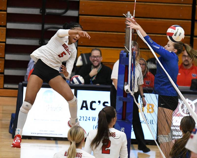 Benet Academy's Brooklynne Brass (5) spikes the ball past St. Charles North's Ellie Sutter (9) during the sectional championship game on Thursday Nov. 7, 2024, during th 4A sectional championship game held at West Aurora High School.